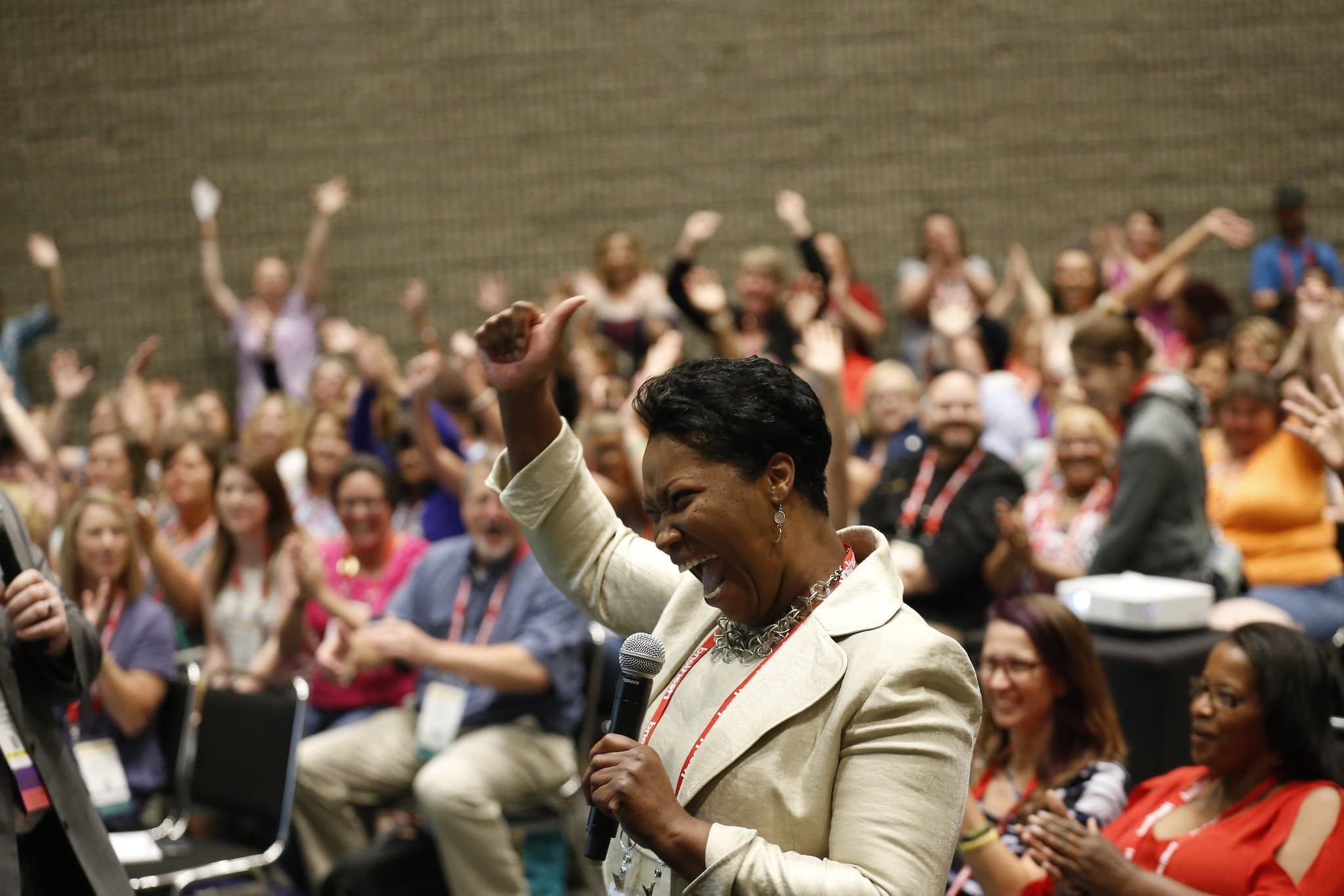 Female speaker motivating crowd