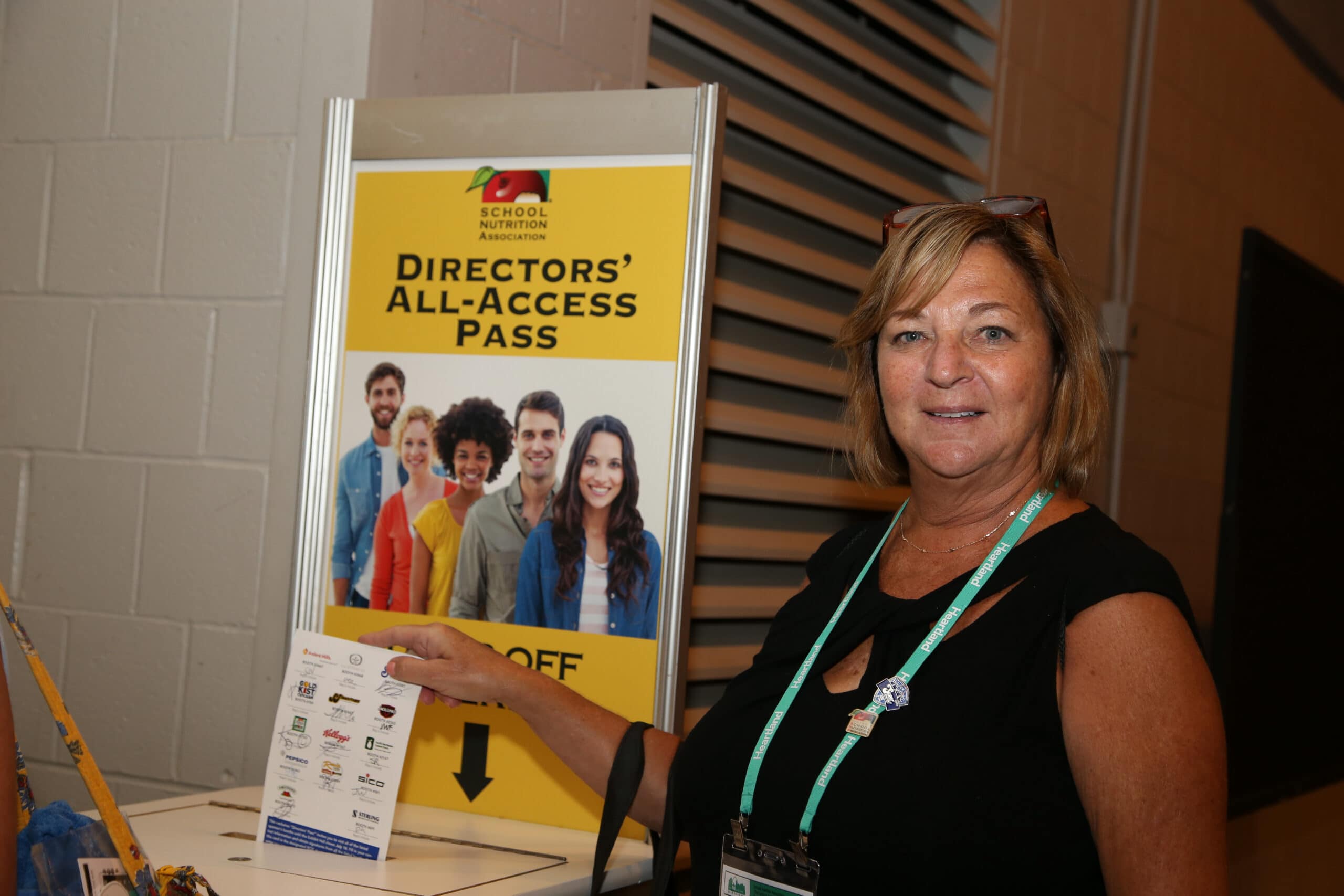 Director All Access Pass A lady putting in the collection box a Director All Access Pass
